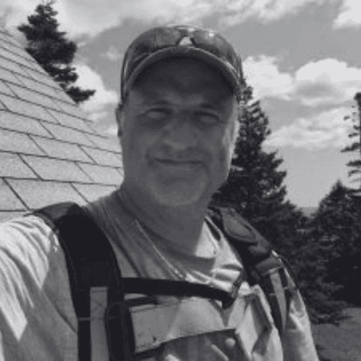 Image of Mario Borsato standing in front of a roof.